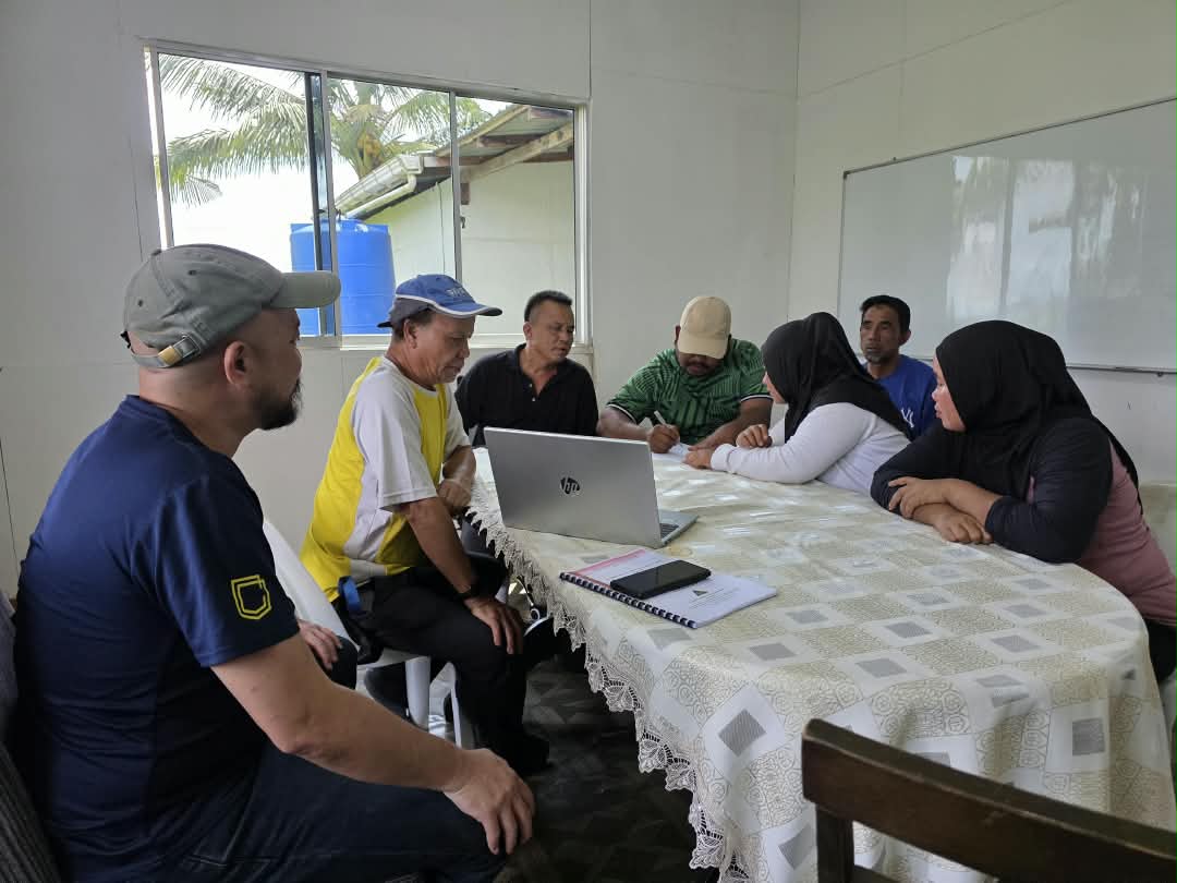 Environmental project team reviewing plans during a community meeting